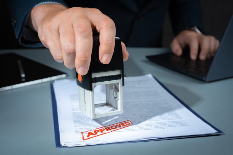 stamp approved. approved stamp, businessman stamping document in office