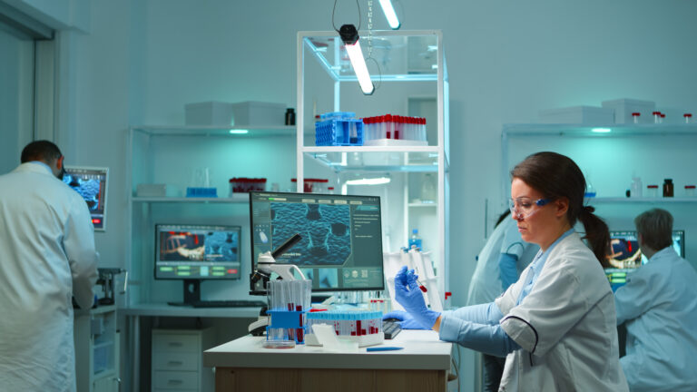 Medical lab worker analyzing blood serum conducting virus test